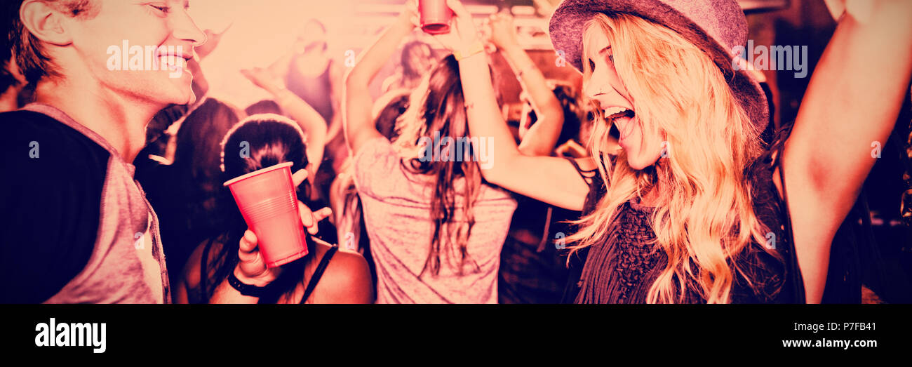 Friends dancing in nightclub Stock Photo