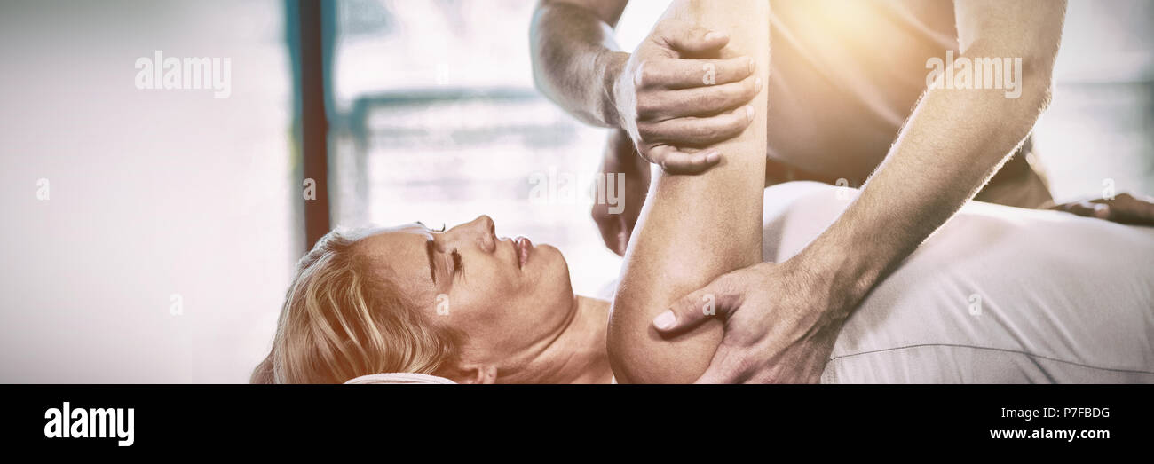 Woman receiving shoulder therapy from physiotherapist Stock Photo