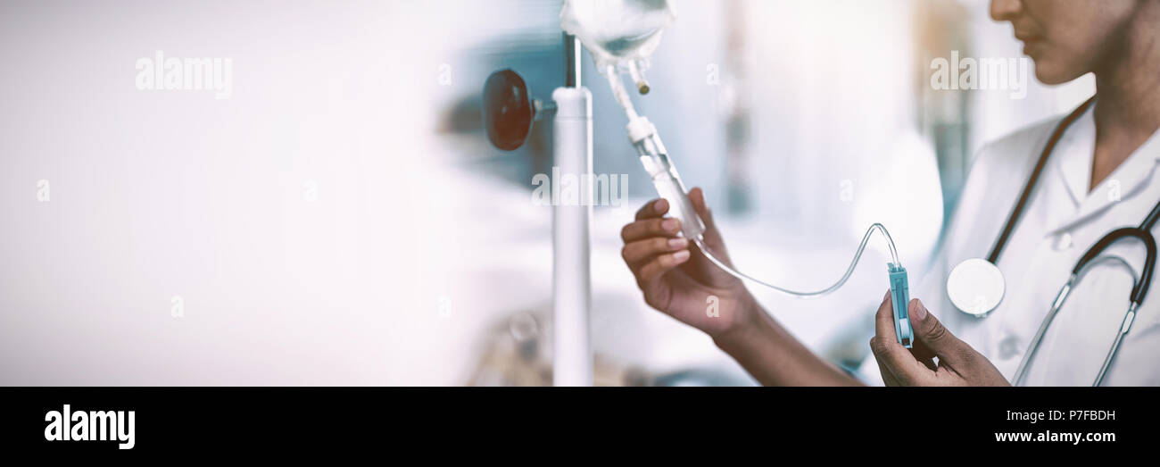 Nurse connecting an intravenous drip Stock Photo