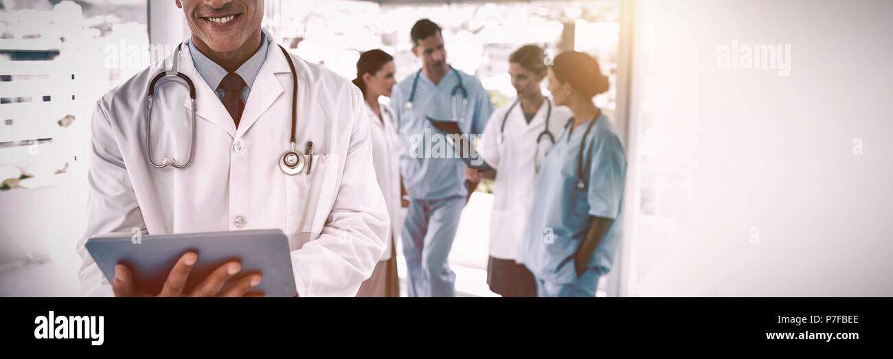 Smiling doctor holding digital tablet Stock Photo