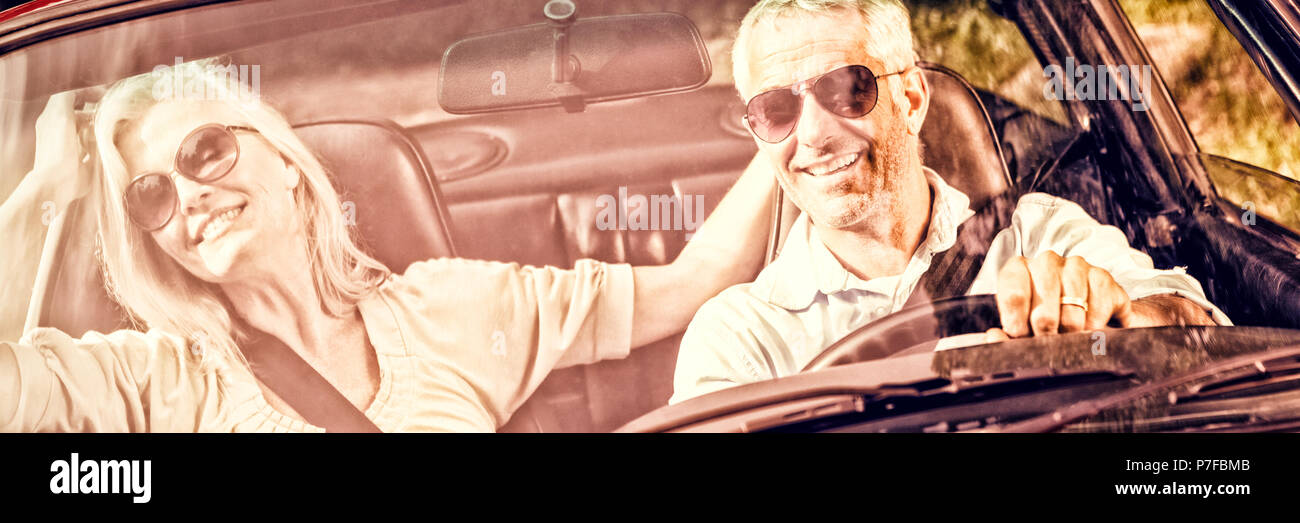 Happy mature couple in red cabriolet Stock Photo
