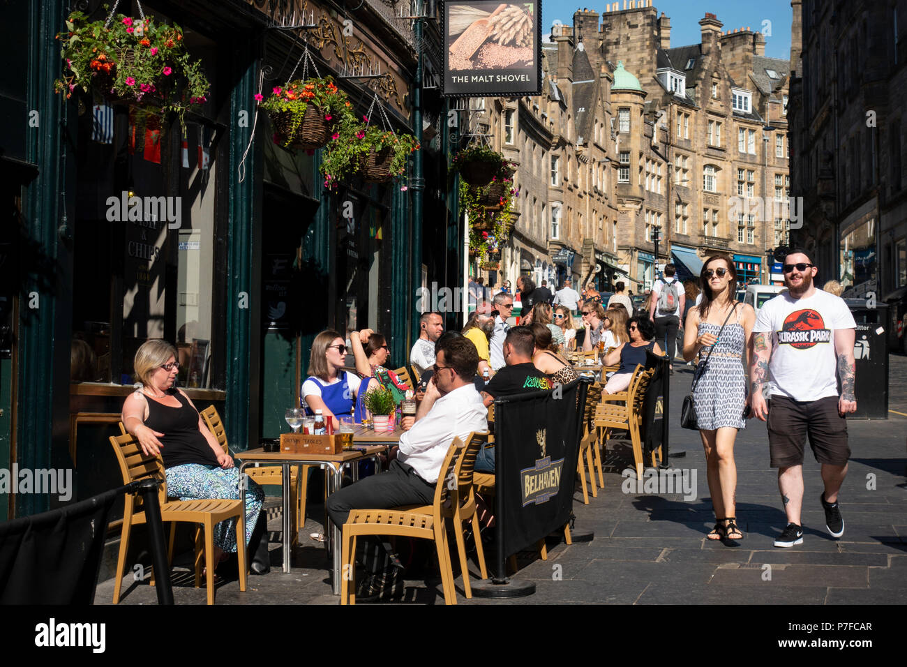 Busy bar with outside seating in summer on Cockburn Street in Old Town