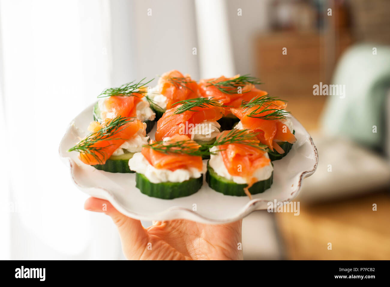 cucumber and salmon, small snacks on a plate. Copy space Stock Photo