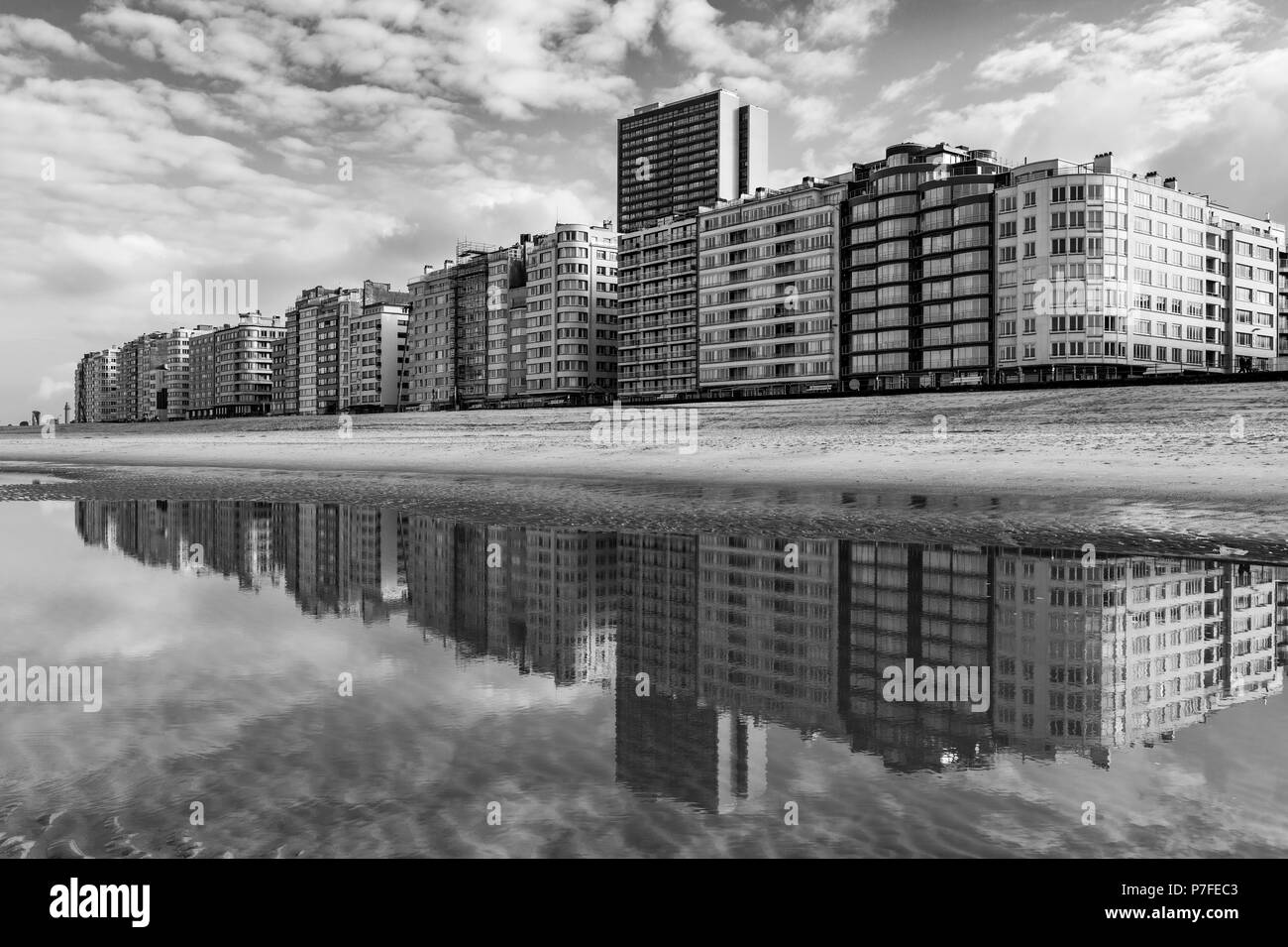 Black and white photograph of the urban skyline reflection of Ostend City with its waterfront and its North Sea beach, West Flanders, Belgium. Stock Photo