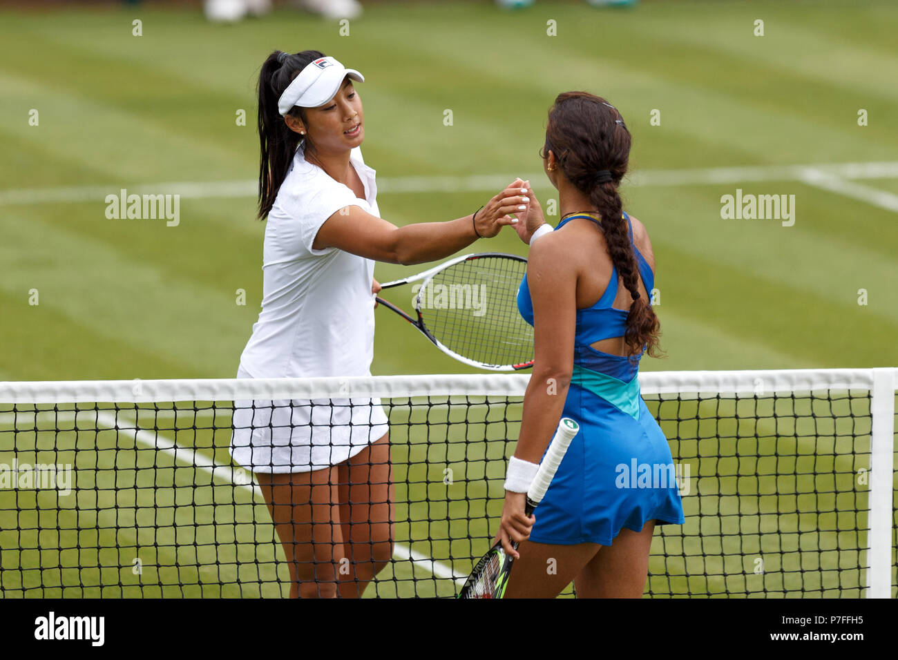 Priscilla Hon (left) and Ankita Raina (right) shake hands at the end of Hon's Women's Singles qualifying win at the 2018 Nature Valley Classic in Birmingham, UK. Stock Photo