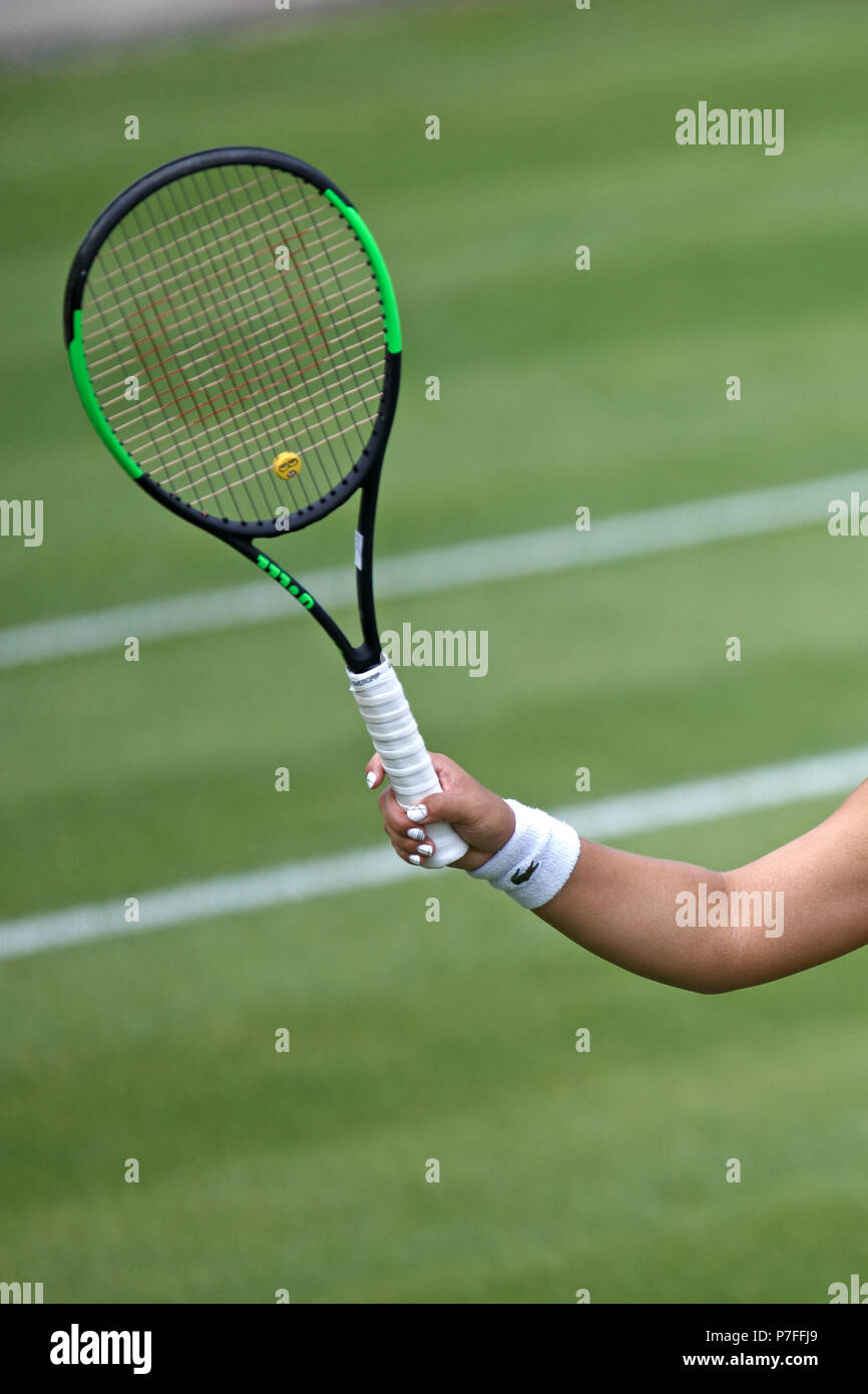 A female professional tennis player holding their racket in a continental grip as they prepare to serve during a match. Tennis technique, continental tennis grip. Stock Photo