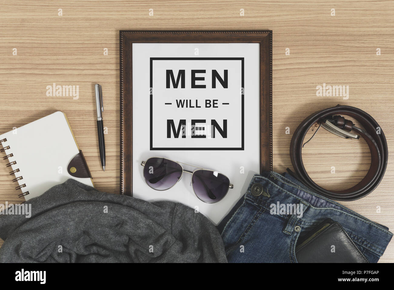 Wood frame with copy space and men's casual outfits and accessories. Fashion flat lay. Stock Photo