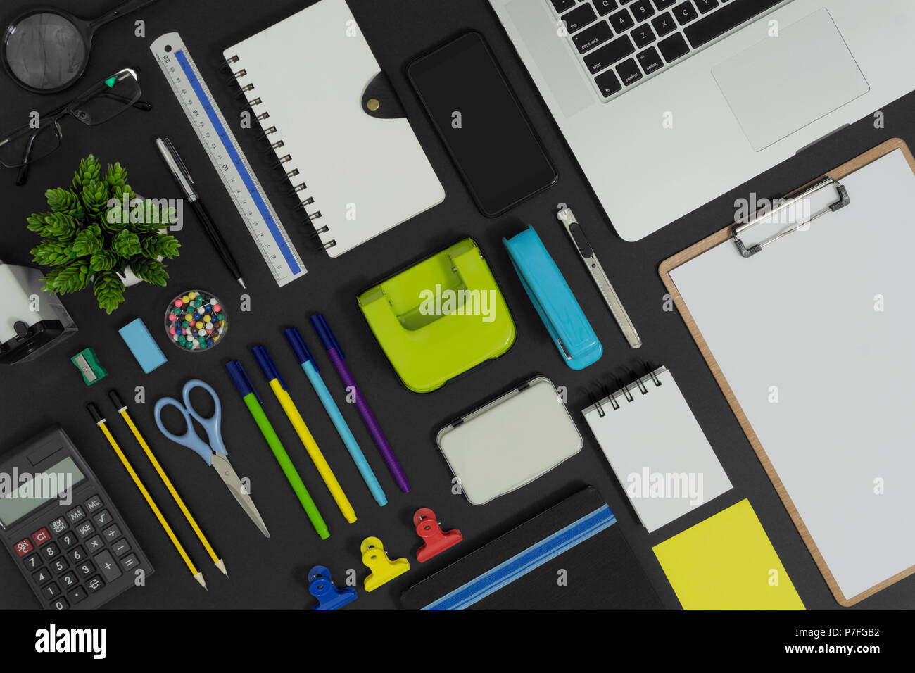 Multiple stationery items and devices for office and school. Top view flat lay of office supply with copy space. Stock Photo