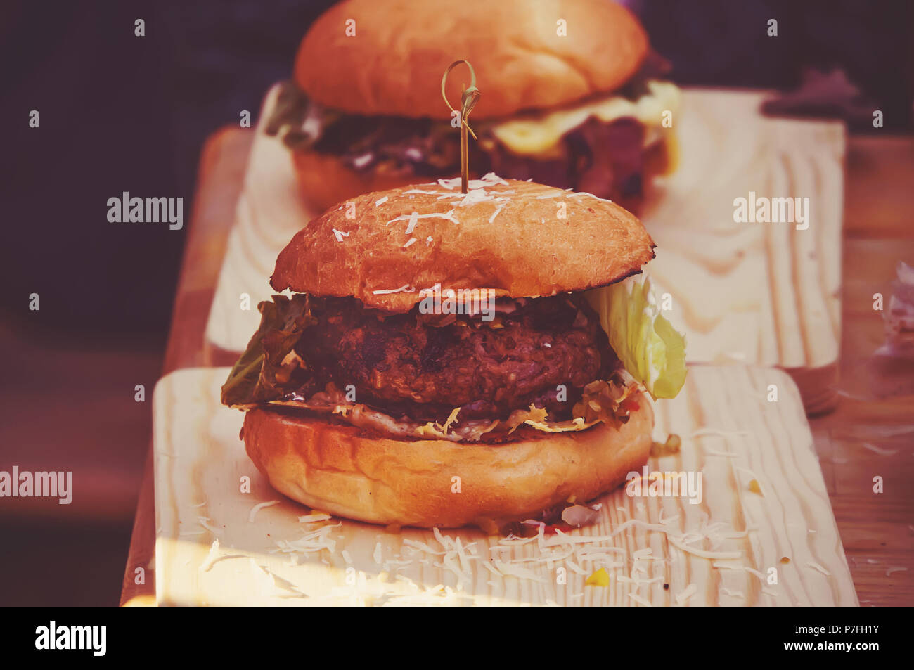 mouthwatering, delicious homemade burger used to chop beef. on the wooden table. The burgers