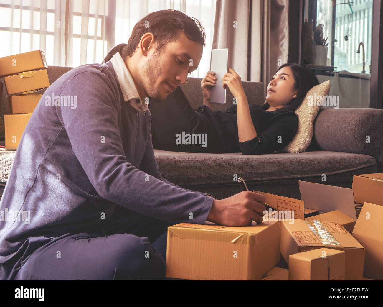 Business life partner is packing boxes for online shop delivery Stock Photo