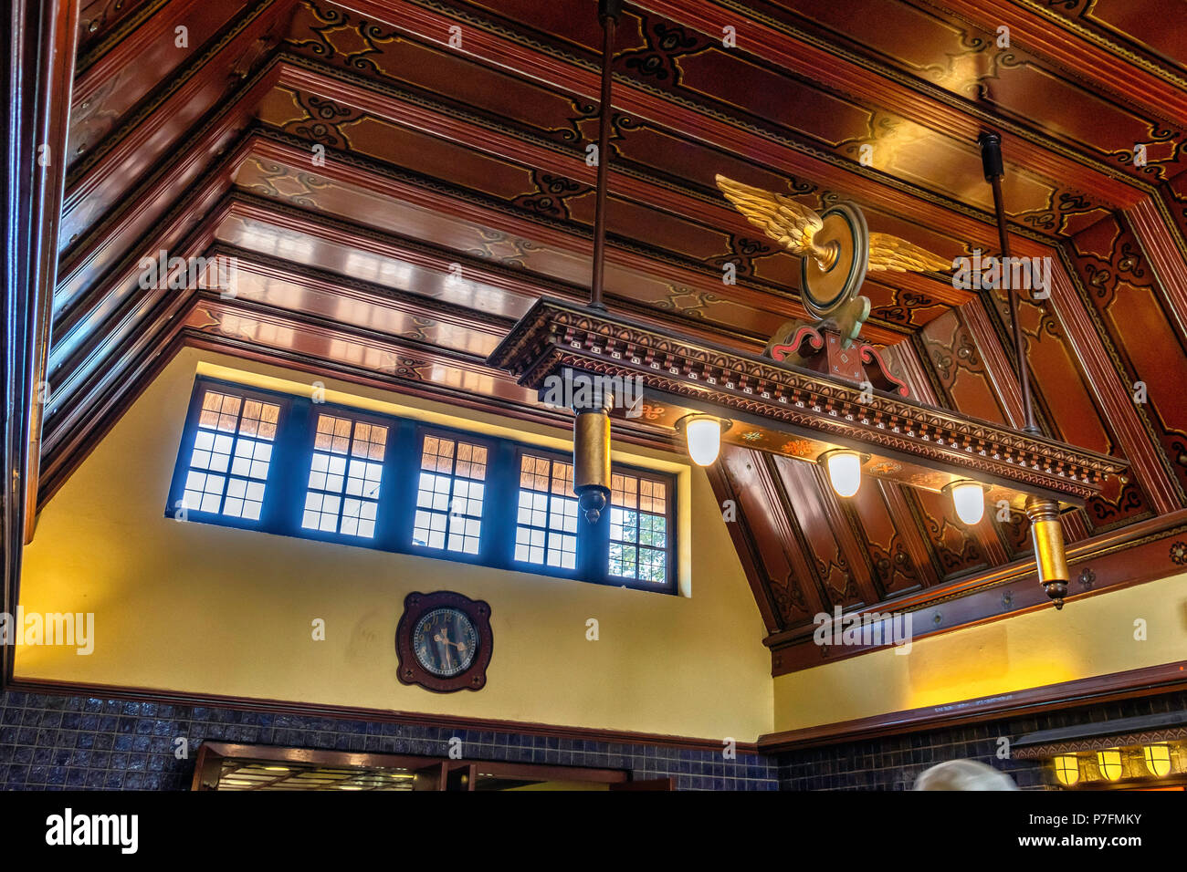 Berlin Dahlem-Dorf U-Bahn underground railway station on the U 3 line. Historic building interior with blue tiles, wood panel ceiling, ornate light. S Stock Photo