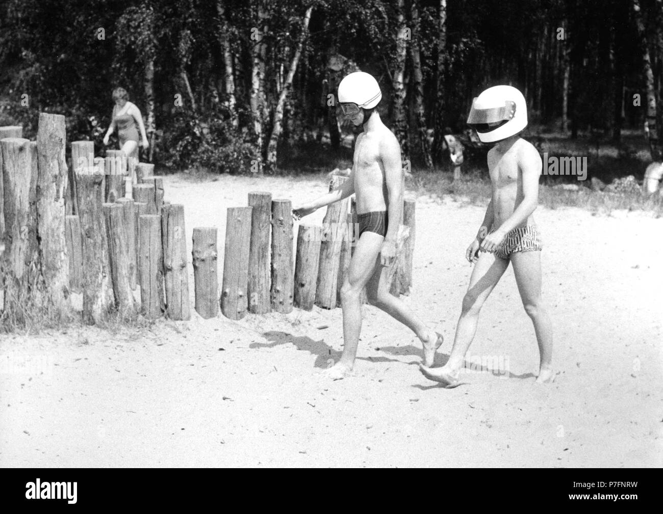 2 with motorcycle helmet on the beach, approx. 1980s, Baltic Sea, GDR, Germany Stock Photo