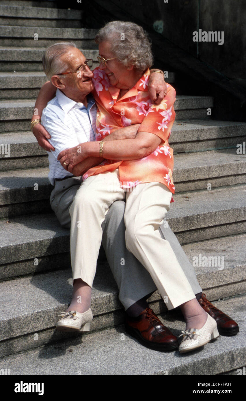 Old couple cuddling, Berlin, Germany Stock Photo