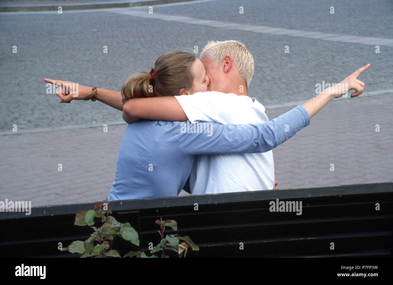 Different views, kissing couple shows in different directions, Berlin, Germany Stock Photo