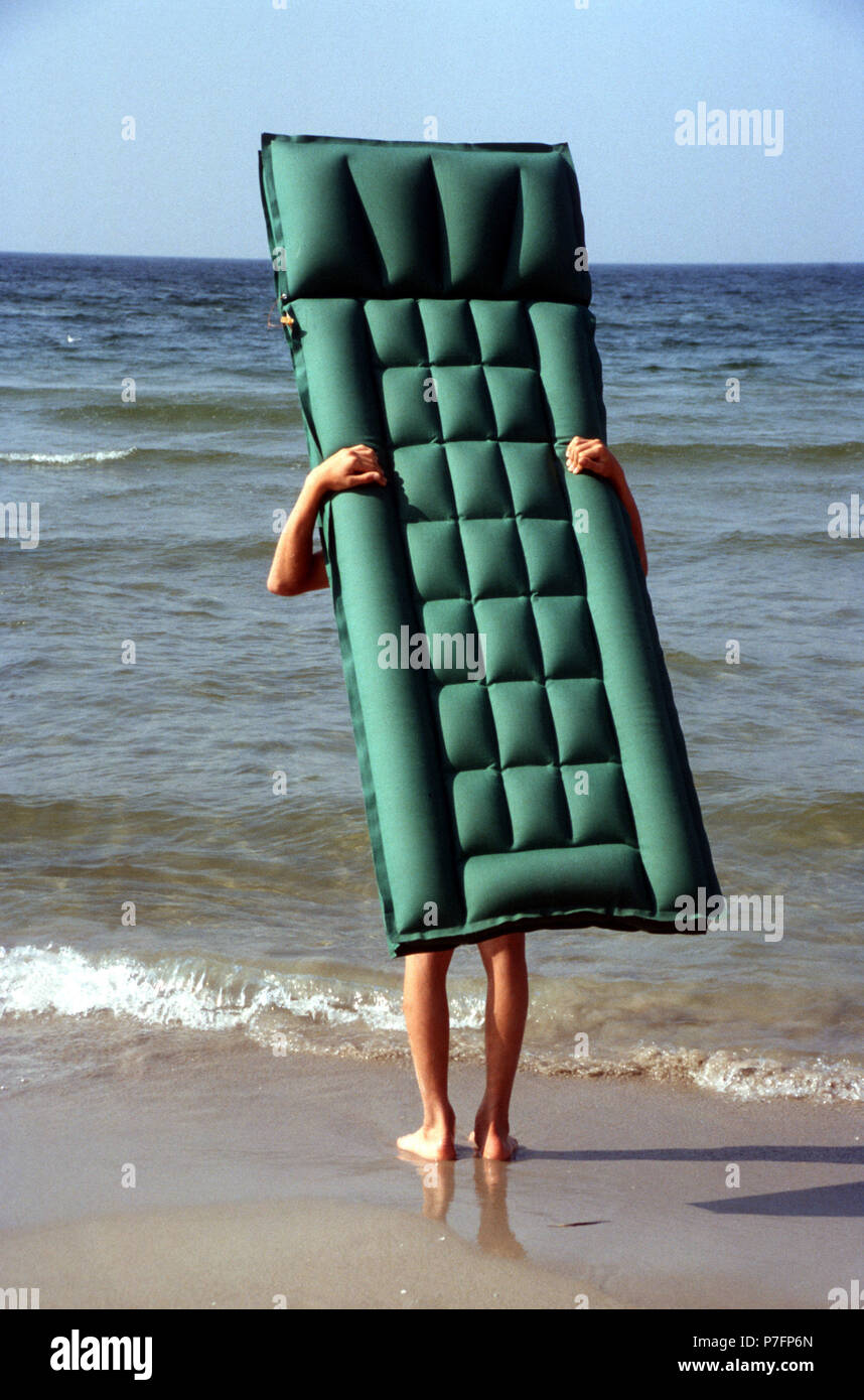 Air mattress with legs on the beach Stock Photo