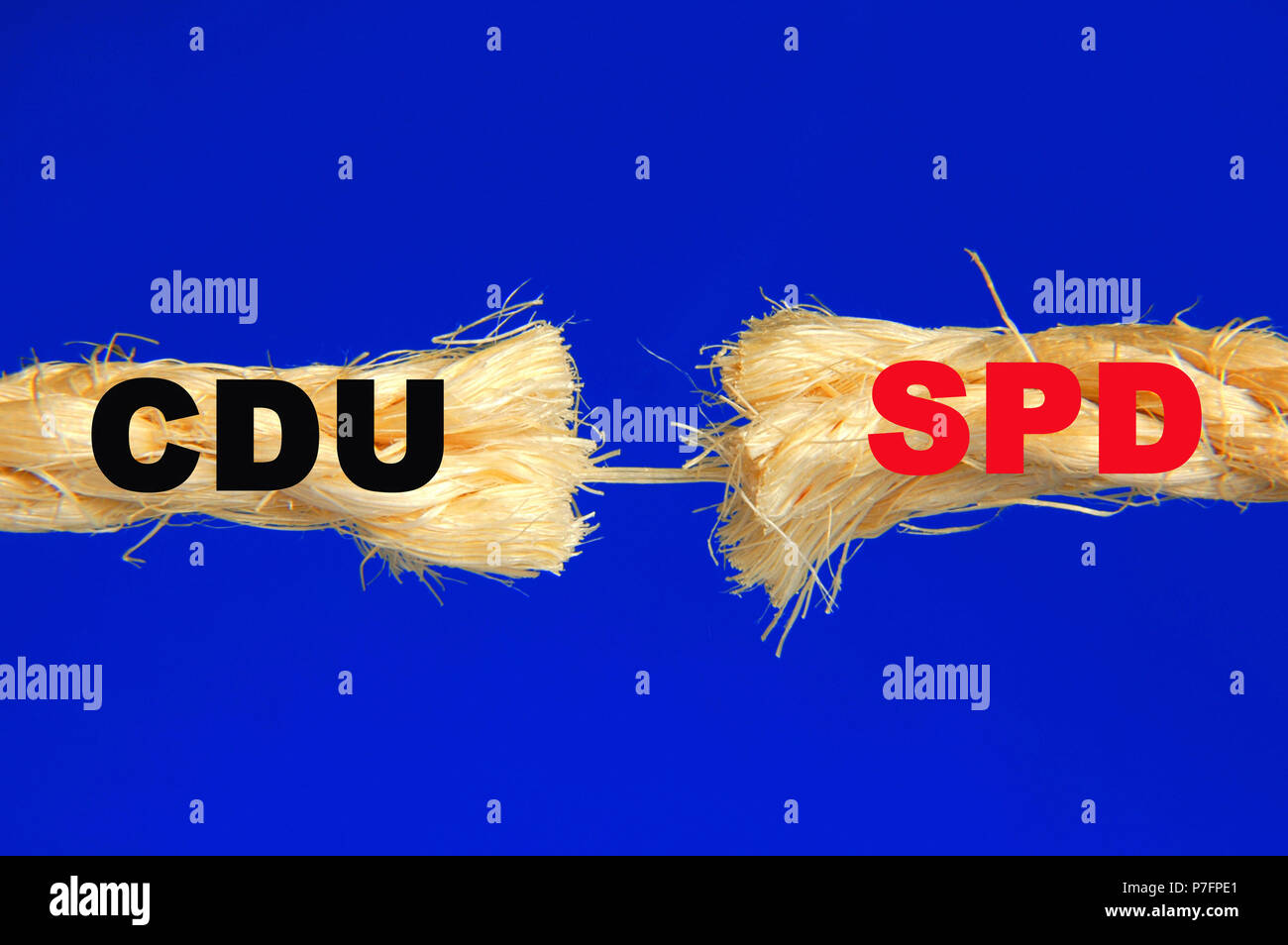 German political parties CDU and SPD lettering on almost torn rope ...