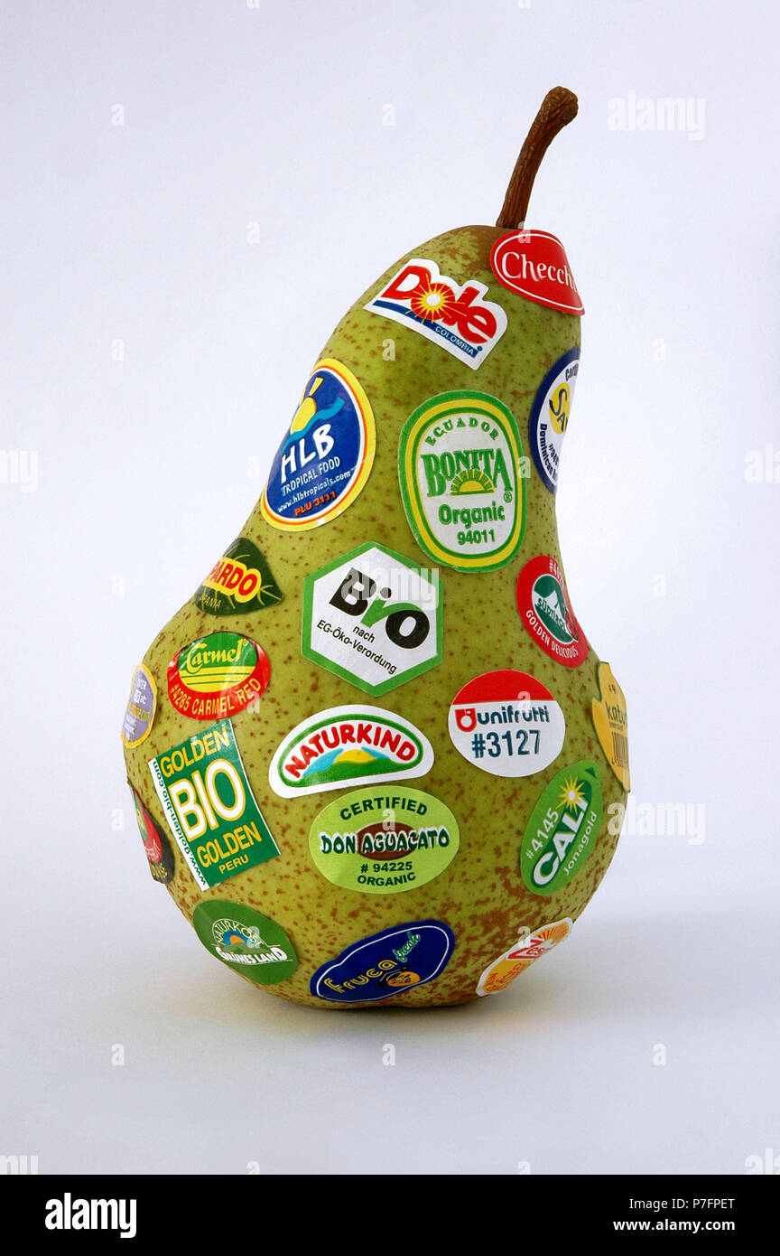 Pear with many stickers, certifications and logos stuck on Stock Photo