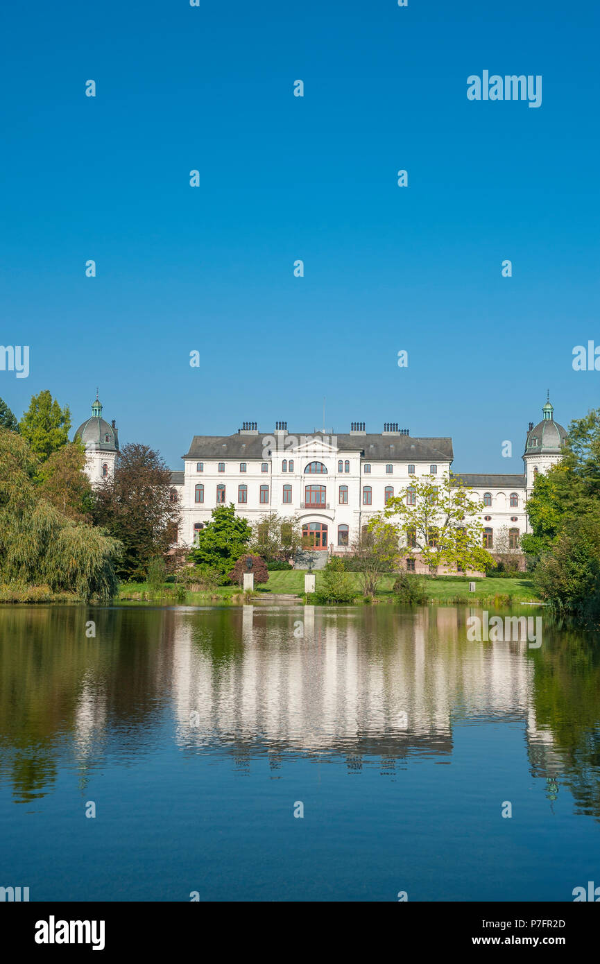 Castle Gut Salzau with reflection in the water, Fargau-Pratjau, Schleswig-Holstein, Germany Stock Photo