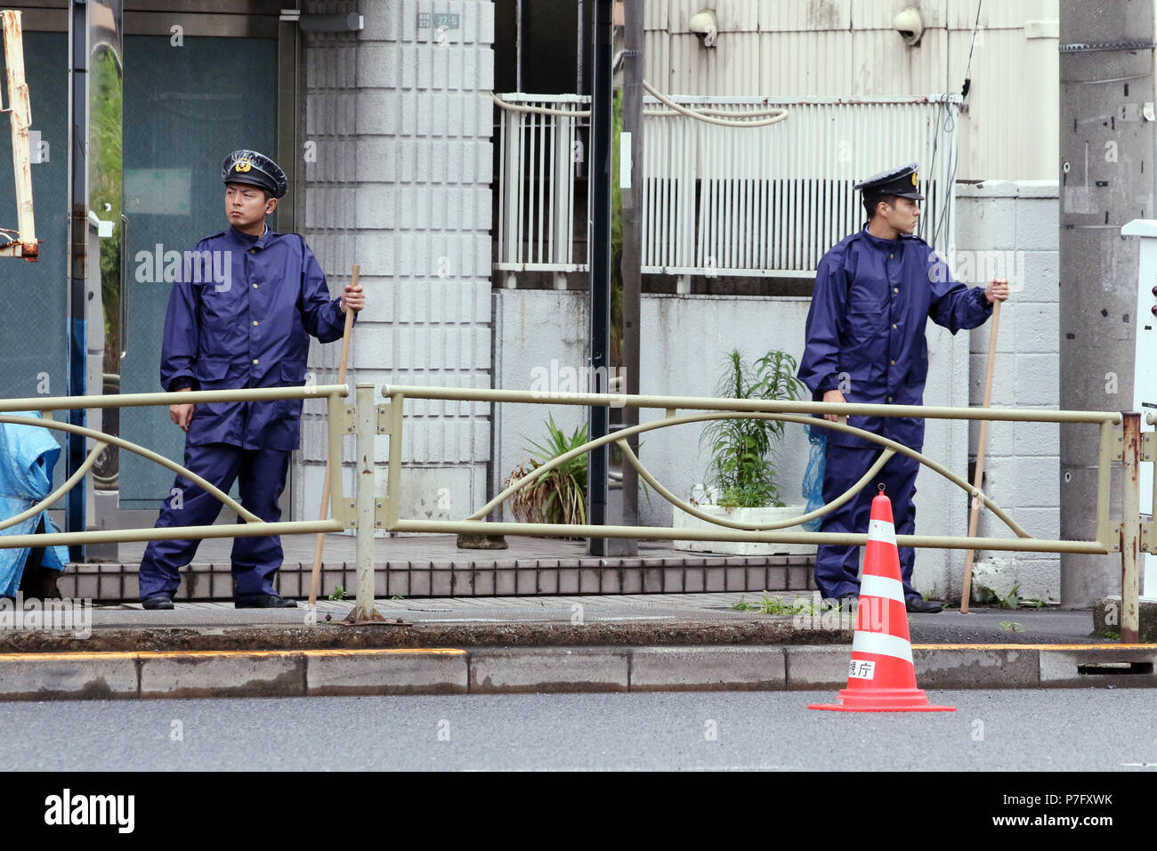 Tokyo, Japan. 6th July, 2018. Police officers stand at the entrance of a facility of a cult group Aleph in Tokyo on Friday, July 6, 2018. Aleph is a succession group of the doomsday cult AUM Shinrikyowhich which killed 29 people by Sarin gas attack at Tokyo subway in 1994. AUM guru Shoko Asahara was excuted at the Tokyo detention center for numerious crimes on July 6. Credit: Yoshio Tsunoda/AFLO/Alamy Live News Stock Photo