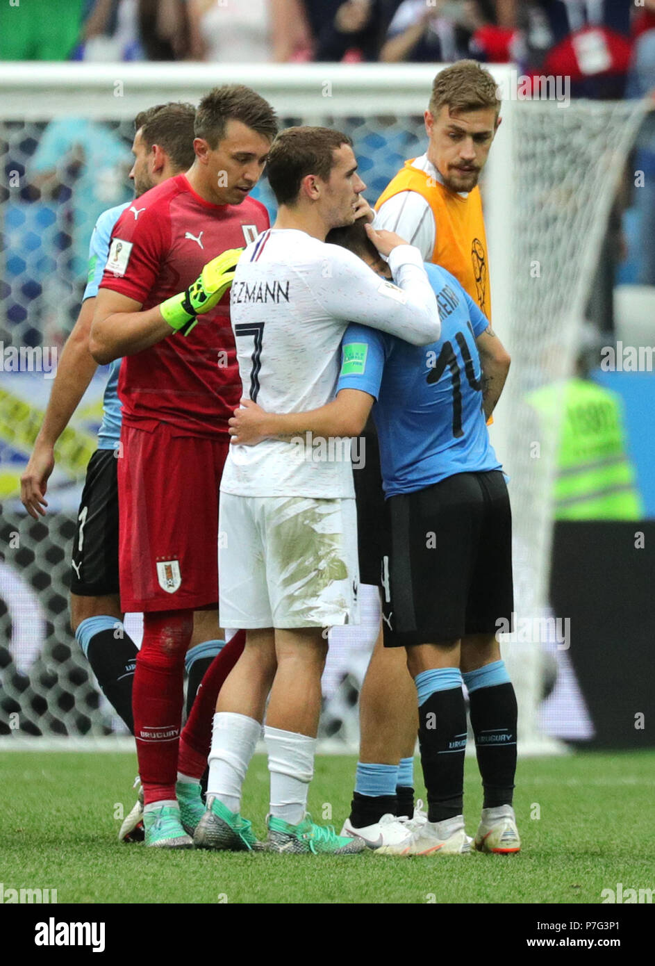 Nizhny Novgorod, Russia. 06th July, 2018. World Cup 2018, Uruguay vs France, Nizhny Novgorod stadium. Lucas Torreira from Uruguay (R) is embraced by Antoine Griezmann (C) from France after the end of the match. Next to them goalkeeper Fernando Muslera of Uruguay. Credit: Christian Charisius/dpa/Alamy Live News Stock Photo