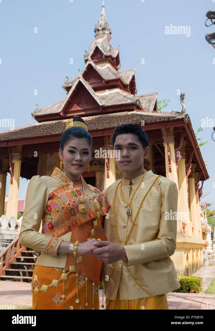 Bride and groom posing in front of Wat Si Saket, Vientiane, Laos, Asia. Stock Photo