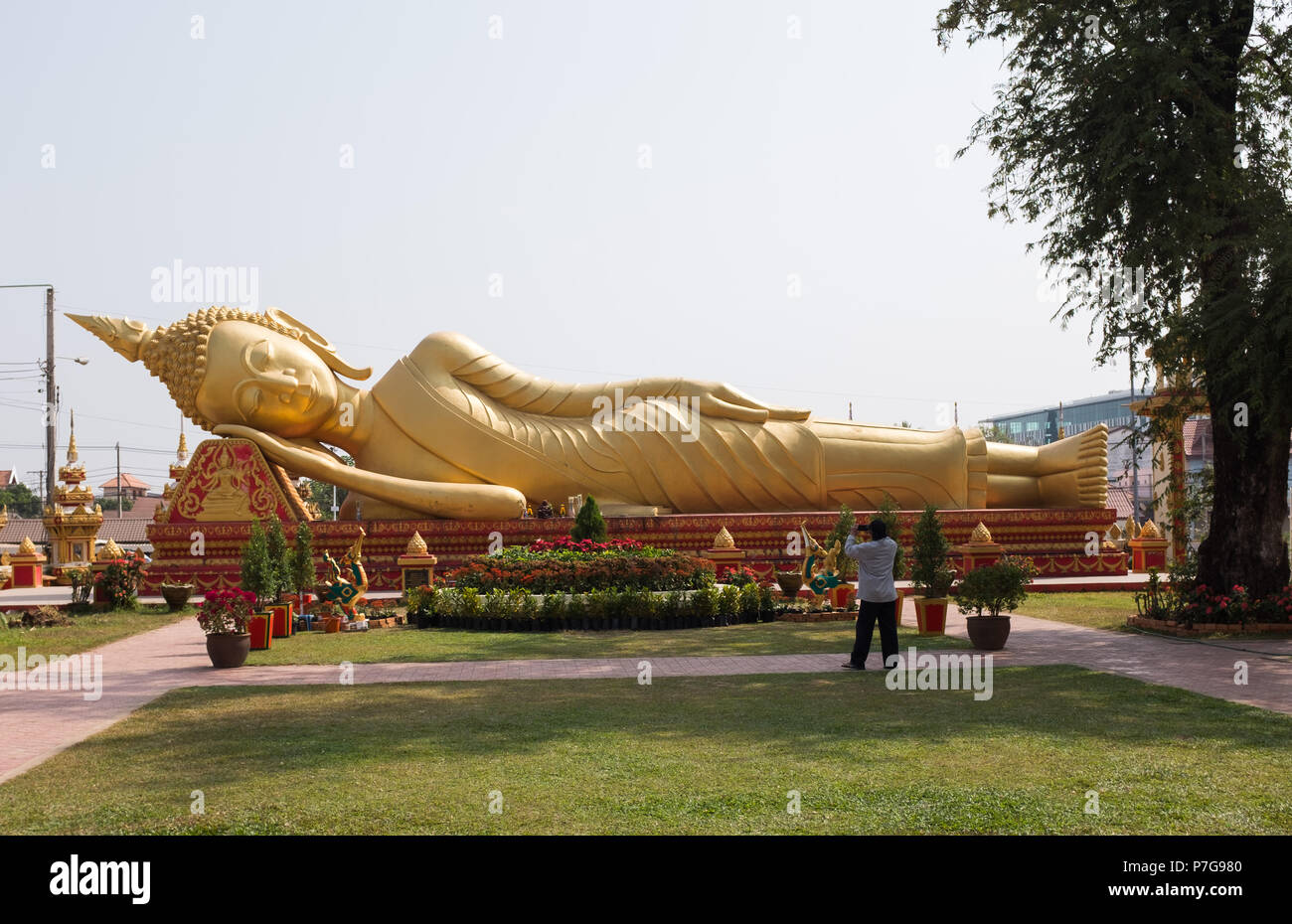 Giant gold reclining Buddha statue near Wat Pha That Luang temple