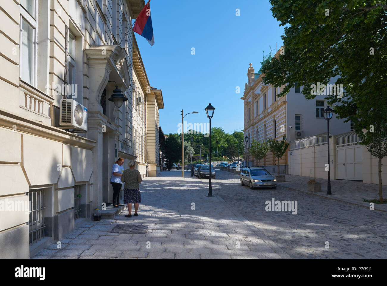 Belgrade, Serbia - May 03, 2018: Morning view on Kosancicev venac street with beautiful old houses on it. Two middle aged women smoking outdoors. Stock Photo