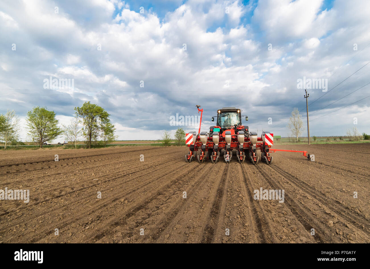 Farmer With Tractor Seeding Sowing Crops At Agricultural Fields In Spring Stock Photo Alamy