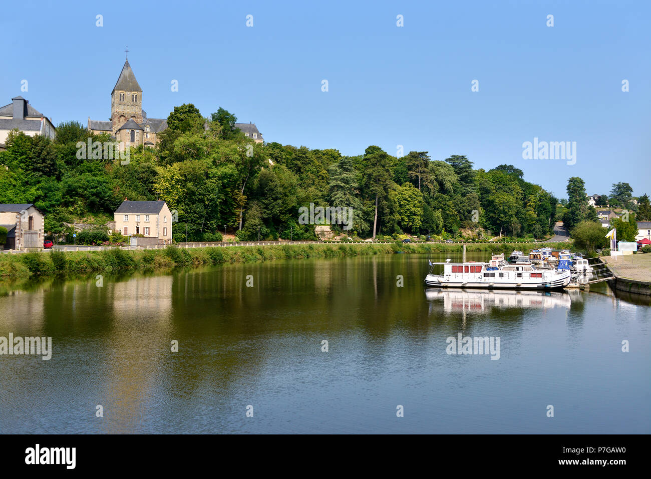 Port on Mayenne river at Château-Gontier with the Saint-Jean-Baptiste church in height, commune in the Mayenne department, Pays de la Loire Region, in Stock Photo