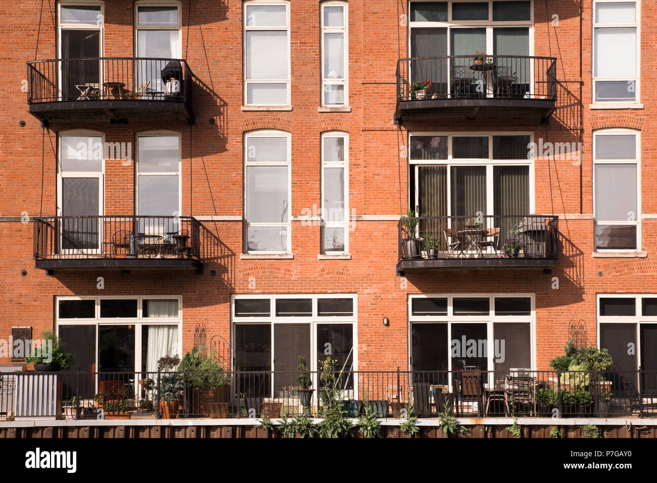 View of apartment building exterior with windows and balconies Stock