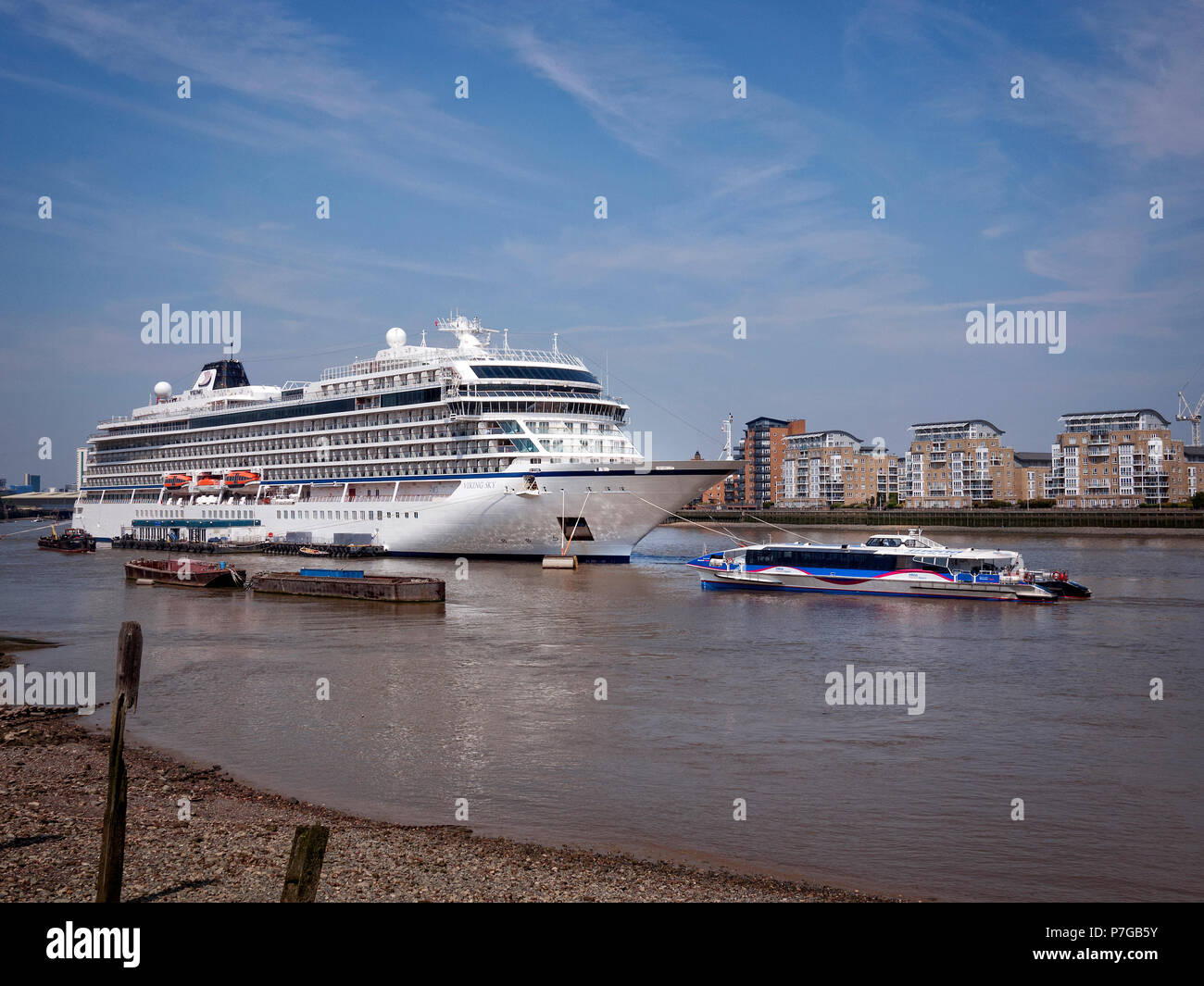 Cruise Liner Viking Sky moored uo at Greenwich London UK. Thames Clipper sailing by.. Stock Photo