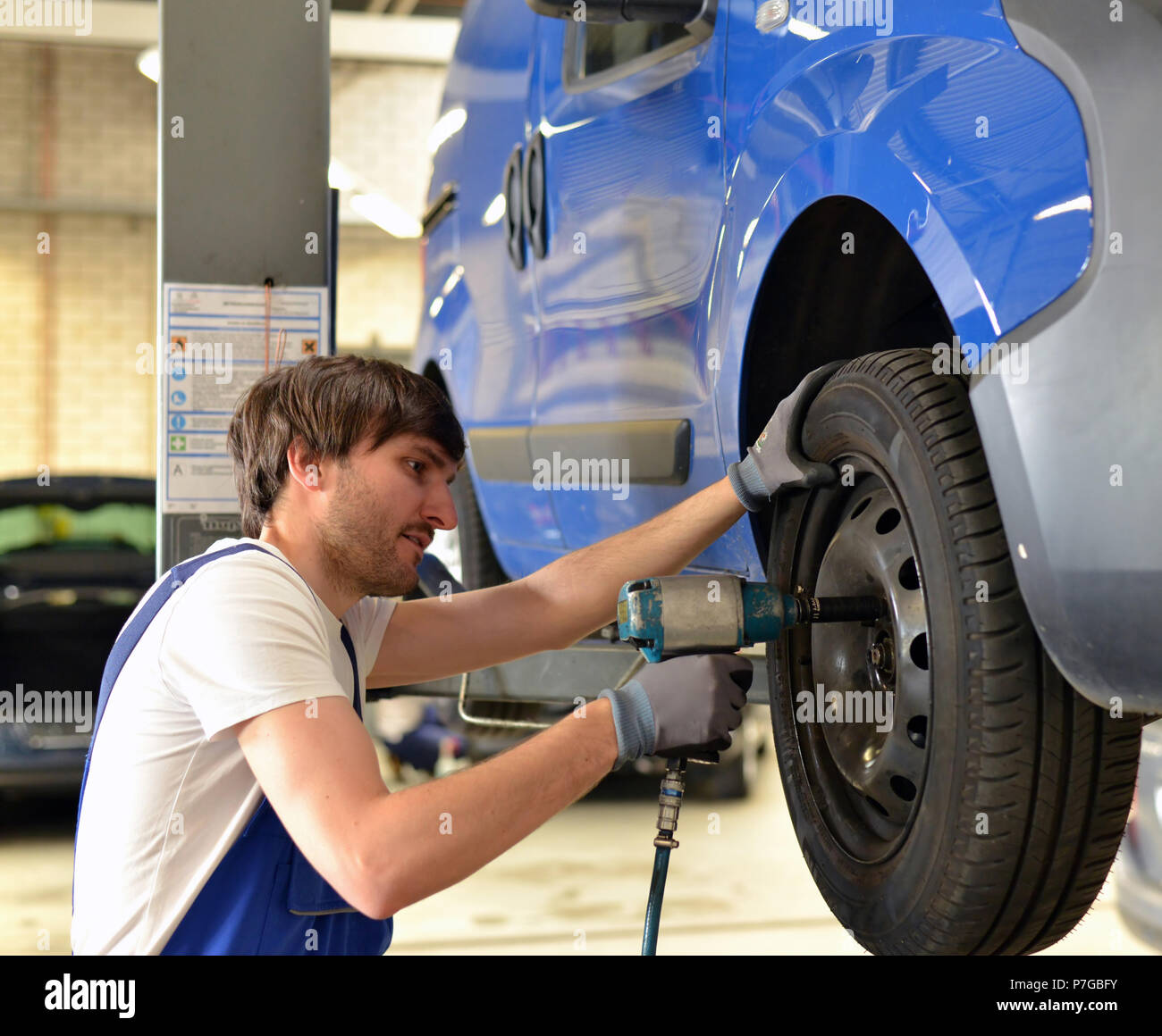 tyre change on the car by mechanics in a Stock Photo Alamy