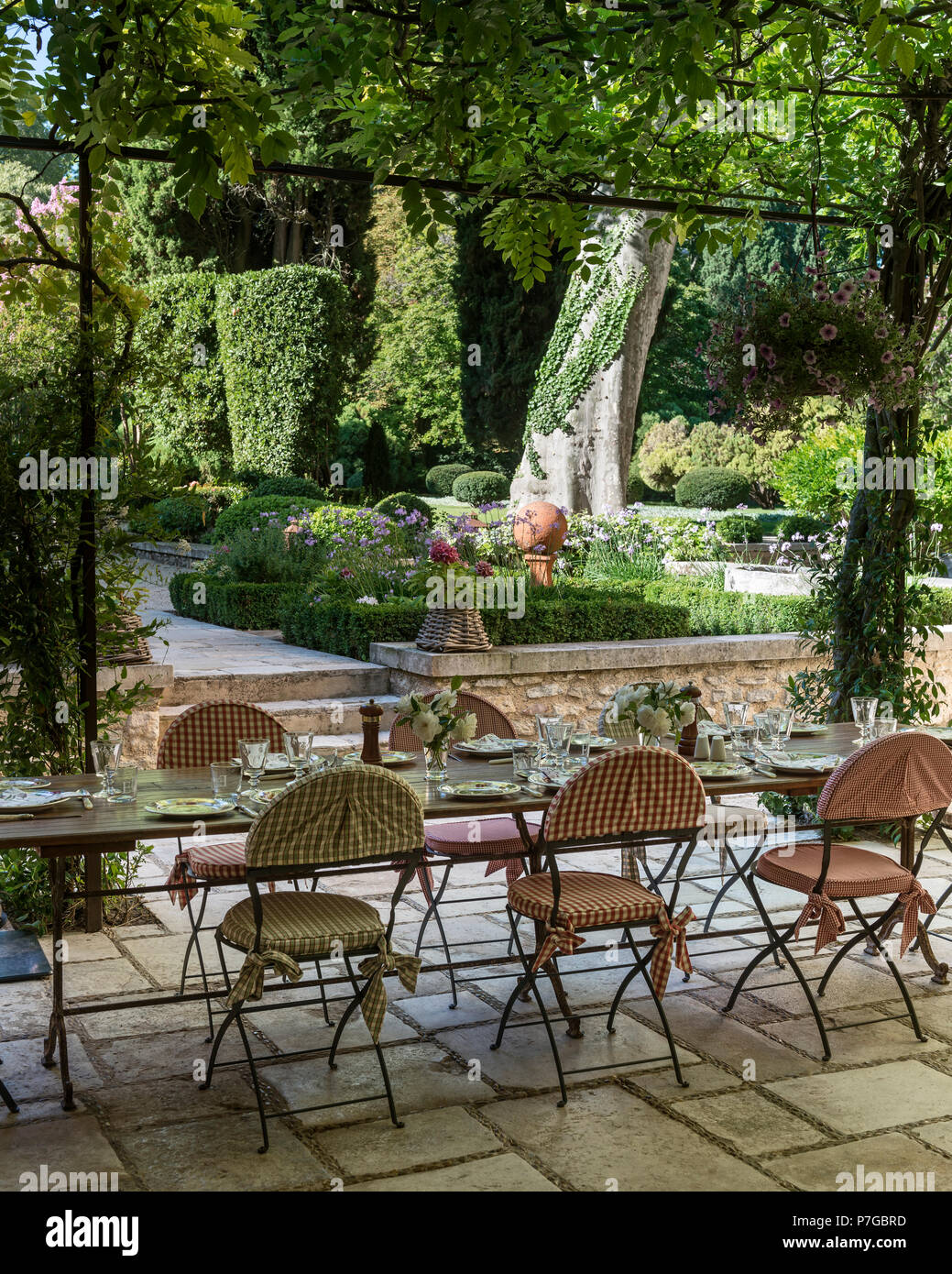 Table and chairs under pergola on terrace of 18th century chateaux, St Remy de Provence Stock Photo