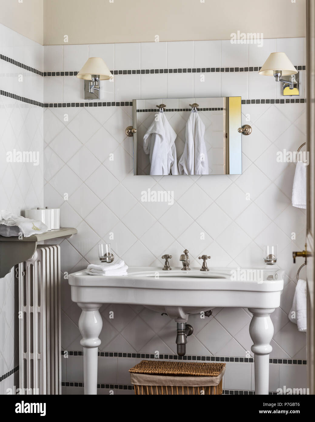 Bathrobes reflected in mirror above sink in 18th century chateaux, St Remy de Provence Stock Photo