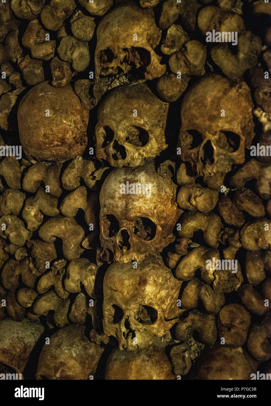 A sculpture in the Catacombs of Paris made of of Human bones and skulls. Truly a grim and fascinatingly grisly piece of art. Stock Photo