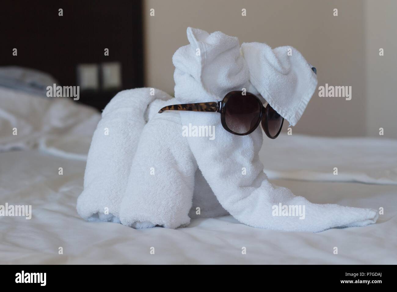 elephant laid out of white towels in a hotel room Stock Photo