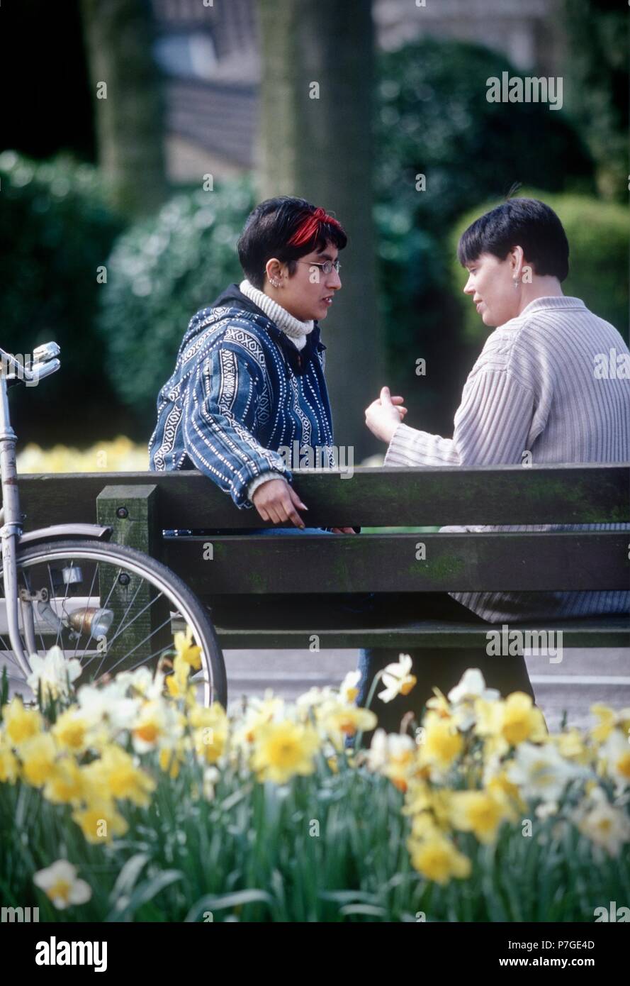 100-014-045 Lesbian couple chatting outside on bench Stock Photo