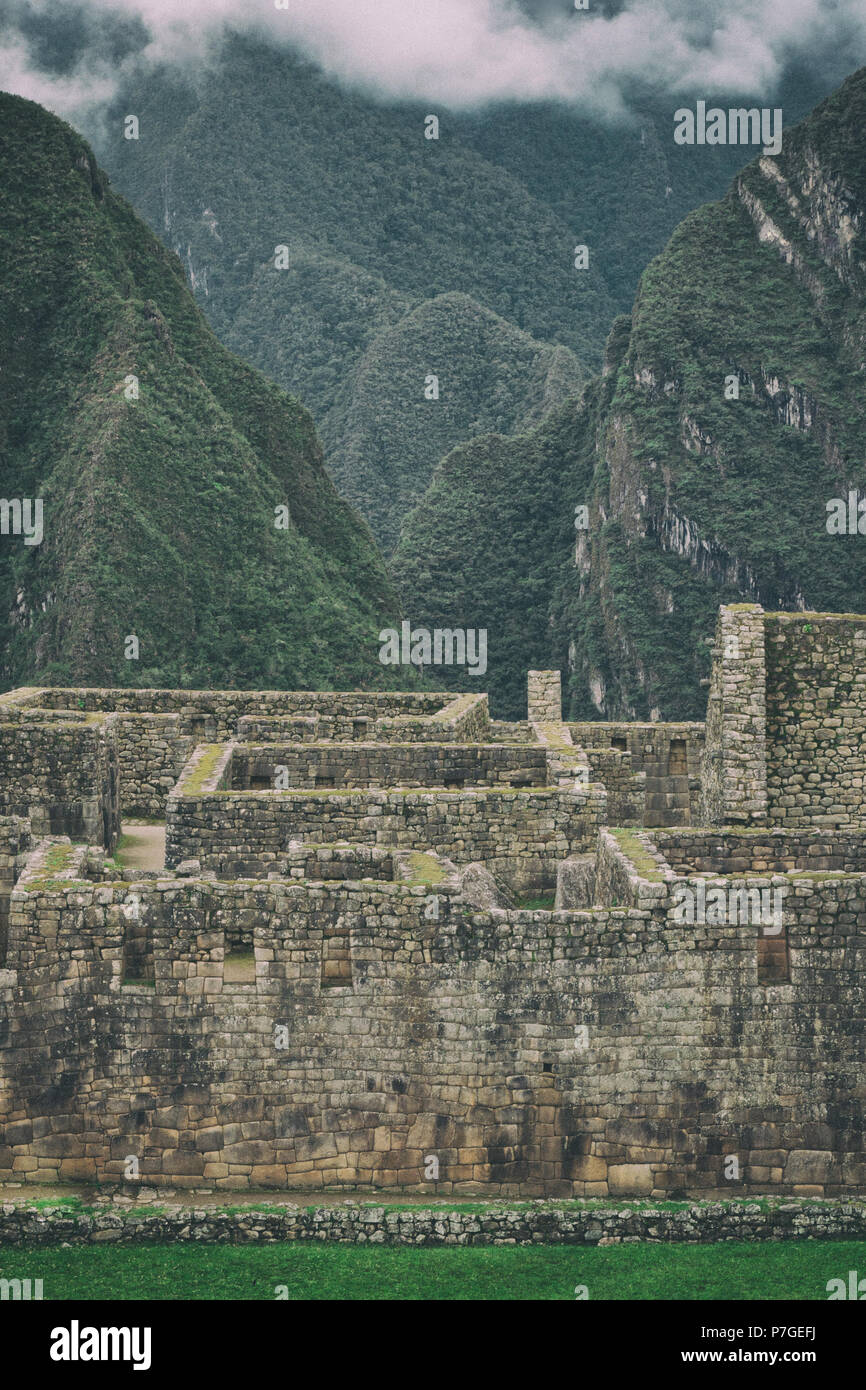 Vertical view of Machu Picchu stone ruins lost in the wild nature of ...