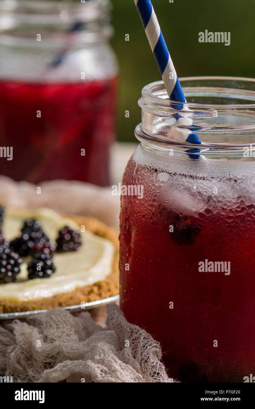 Canning jar glasses of blackberry iced tea Stock Photo