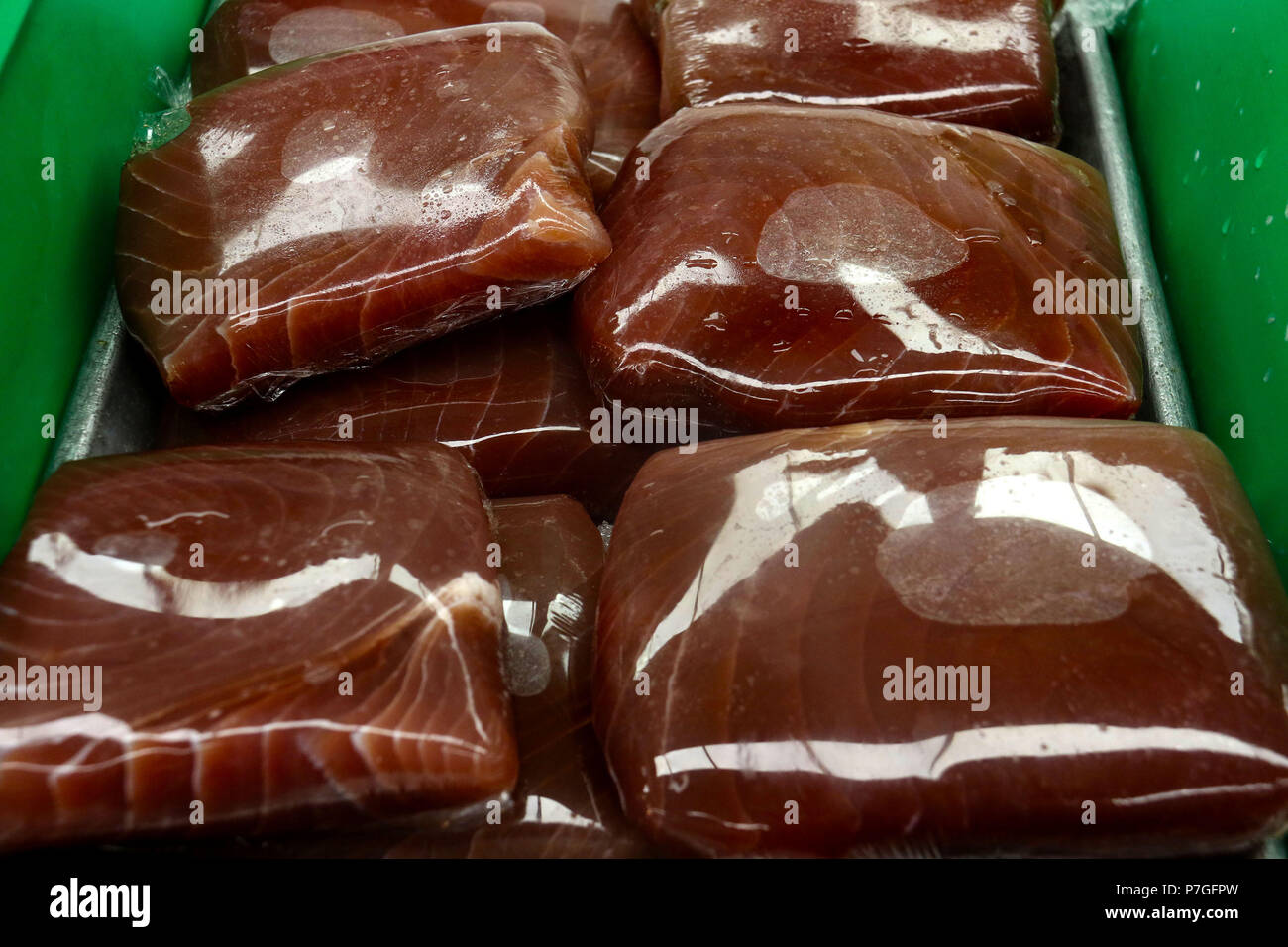 Tuna wrapped in cellophane at fish market Stock Photo
