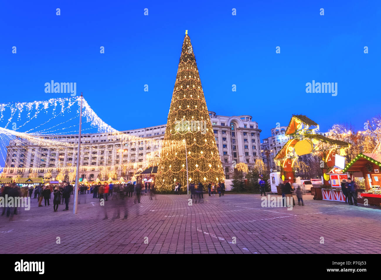 Christmas tree in winter holiday market of Bucharest. People celebrating Christmas outdoor in the main square of the Capital Stock Photo
