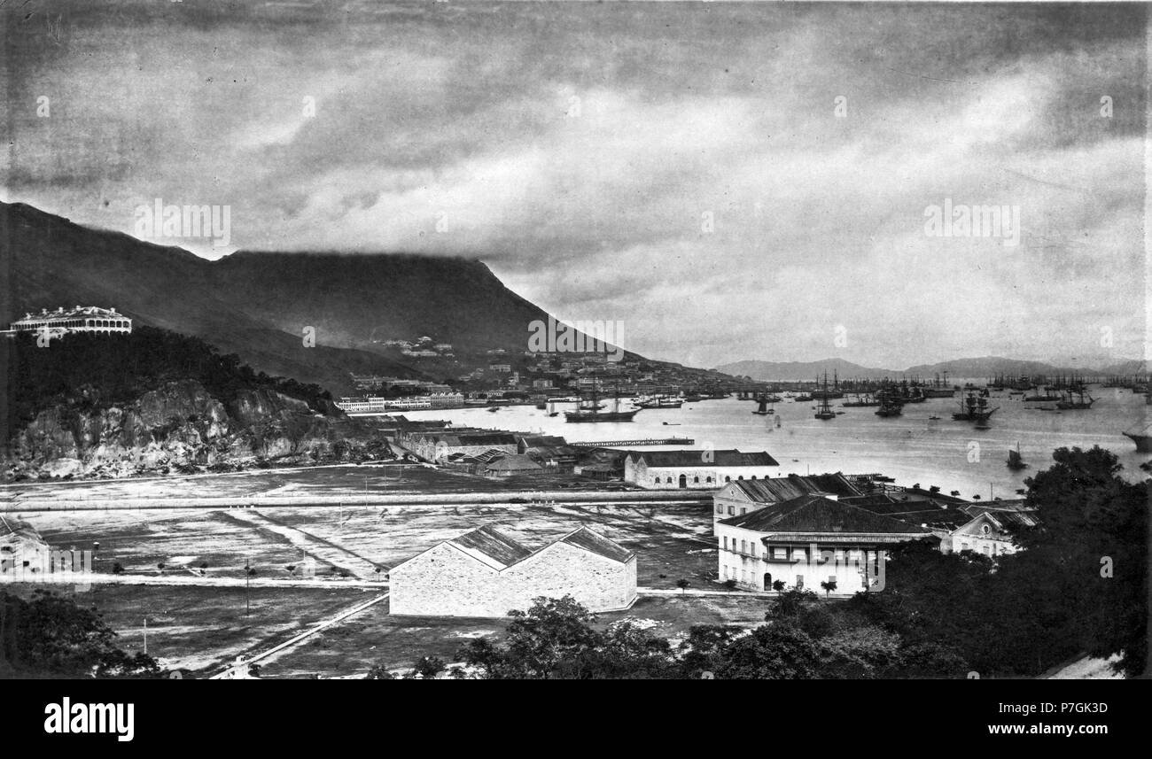 English: John Thomson: HONG-KONG is one of a group of islands situated a little north of the mouth of the Canton or Pearl river. It is about ten miles long, by four and a-half in breadth, and of igneous formation. From east to west, along its entire length, there runs a central rocky ridge or spine, chiefly composed of granite, and broken up into a series of jagged peaks, whose greatest elevation is 1,900 feet. Viewed from a distance, Hong-Kong may be readily distinguished from the islands which surround it by the bold outlines, and superior altitude, of its hills. The contrast in many cases b Stock Photo
