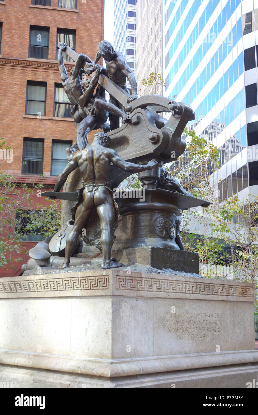 English: Mechanics Monument by Douglas Tilden (1860-1935), located at the intersection of Market, Bush and Battery Streets in San Francisco, California, United States. Dedicated on May 15, 1901. It was was originally to be called the Donahue Memorial Fountain, as it was funded by businessman James Mervyn Donahue. This artwork is in the  because the artist died more than 70 years ago. 28 June 2014, 13:07:15 265 Mechanics Monument by Douglas Tilden - San Francisco, CA - DSC03539 Stock Photo