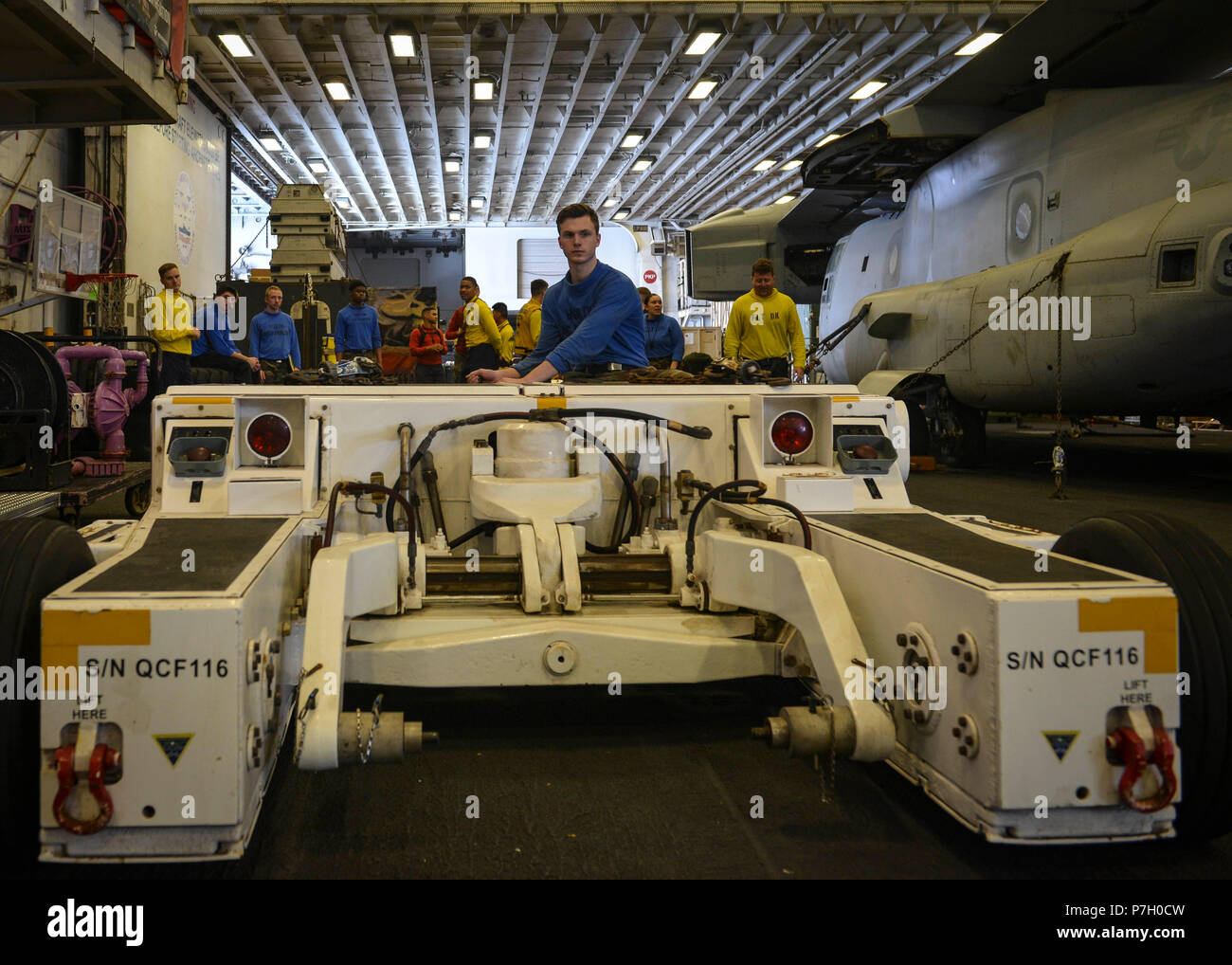 180626-n-ah771-0013-us-5th-fleet-area-of-operations-june-26-2018-airman-tanner-wisniewski-from-niagra-falls-new-york-drives-an-as32-32a-spotting-dolly-in-the-hangar-bay-of-the-wasp-class-amphibious-assault-ship-uss-iwo-jima-lhd-7-june-26-2018-iwo-jima-homeported-in-mayport-fla-is-on-deployment-to-the-us-5th-fleet-area-of-operations-in-support-of-maritime-security-operations-to-reassure-allies-and-partners-and-preserve-the-freedom-of-navigation-and-the-free-flow-of-commerce-in-the-region-us-navy-photo-by-mass-communication-specialist-3rd-class-daniel-c-coxwestreleas-P7H0CW.jpg