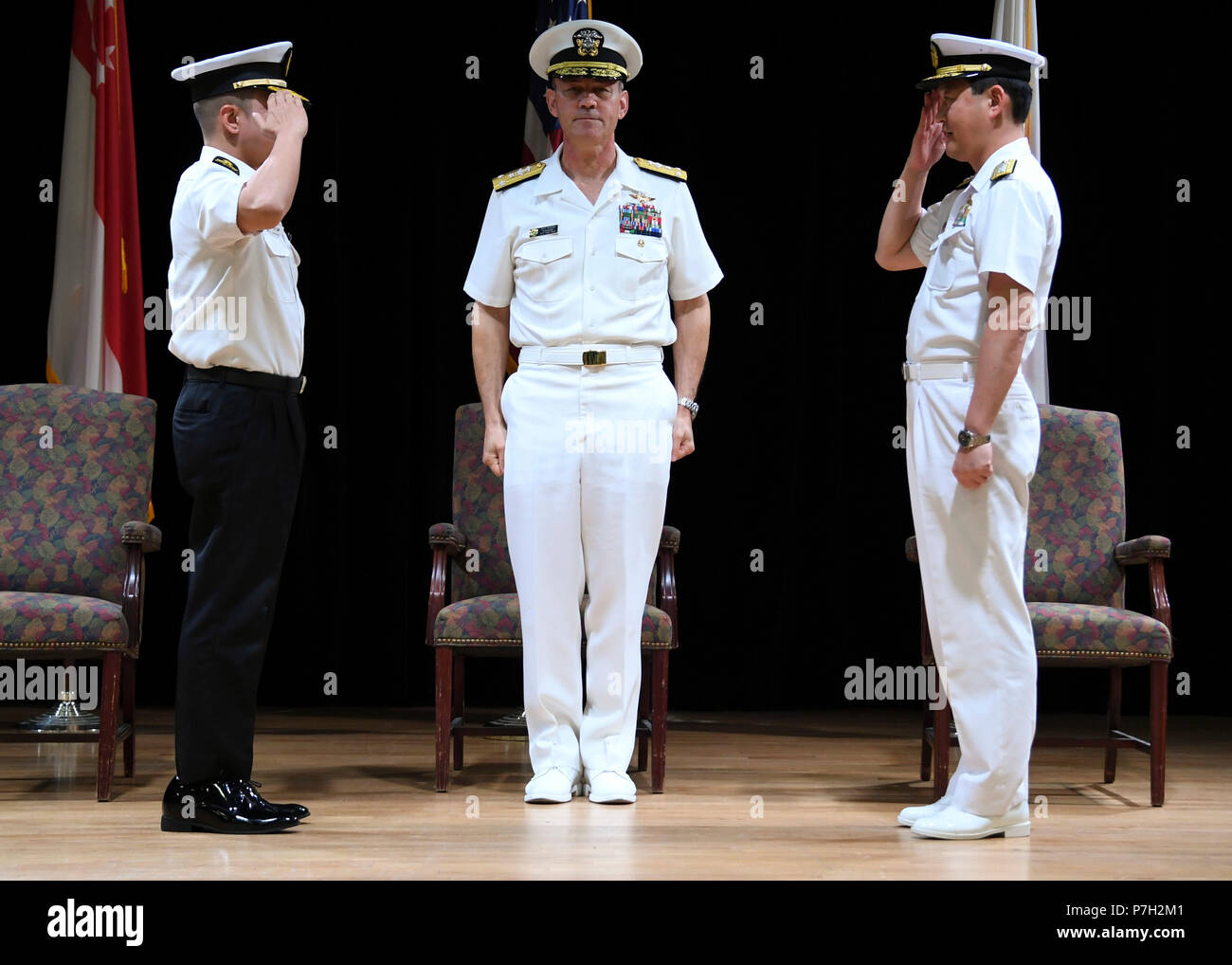 180628-N-RM440-1062 MANAMA, Bahrain (June 28, 2018) Vice Adm. Scott Stearney, middle, commander of U.S. Naval Forces Central Command, U.S. 5th Fleet and Combined Maritime Forces,  presides over a change of command between Republic of Singapore Navy Rear Adm. Saw Shi Tat, incoming commander of Combined Task Force (CTF) 151 left, and Japan Maritime Self-Defense Force Rear Adm. Daisuke Kajimoto, outgoing commander of Combined Task Force (CTF) 151 during the task force's change of command ceremony on Naval Support Activity Bahrain. CTF 151's mission is to disrupt piracy at sea and to engage with r Stock Photo