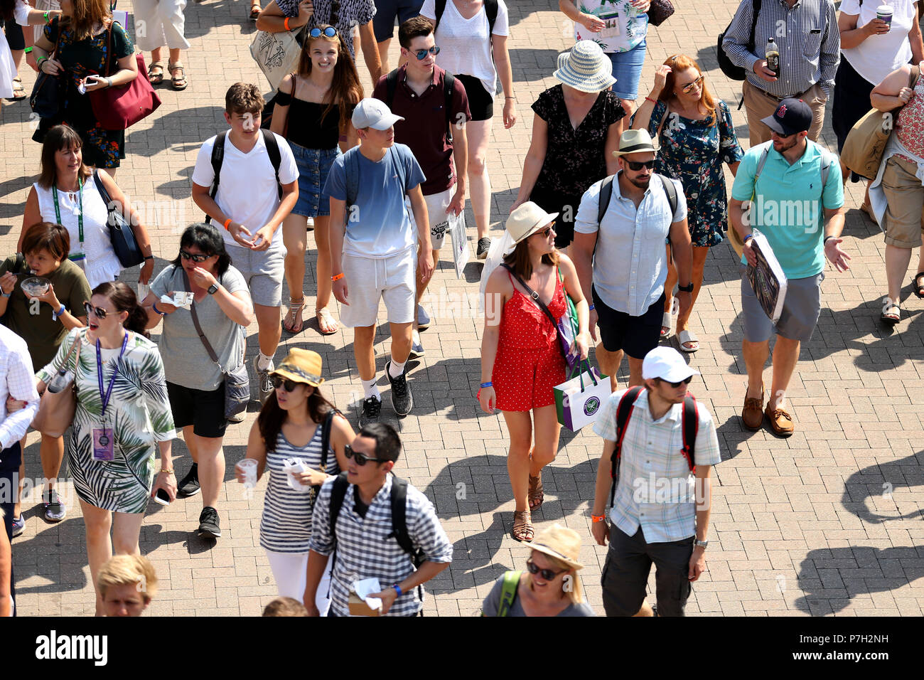 Spectators are led into the grounds at the start of day five of the Wimbledon Championships at the All England Lawn Tennis and Croquet Club, Wimbledon. Stock Photo