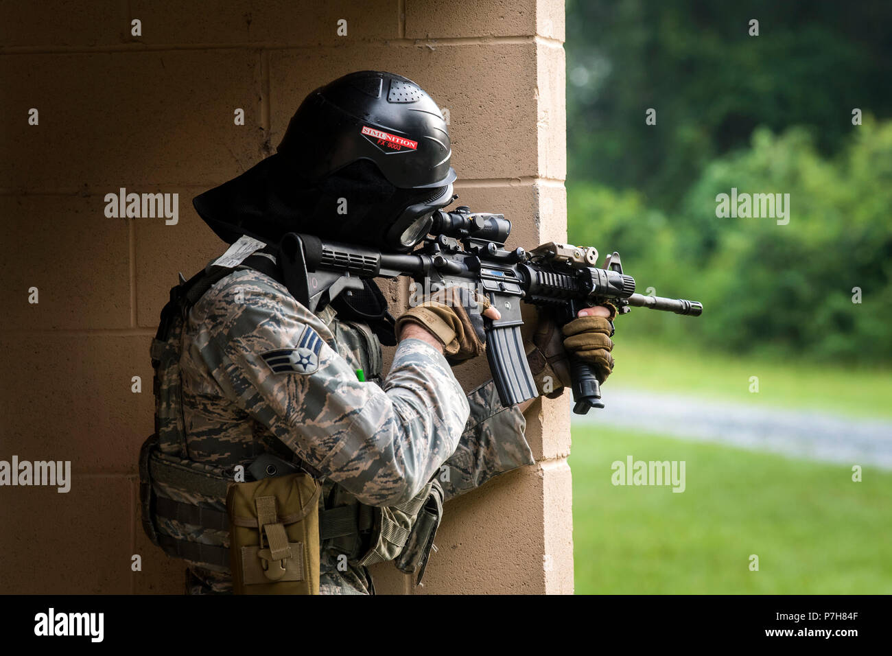 An Airman from the 23d Security Forces Squadron (SFS) fires an M4 carbine during a Force on Force training scenario, June 29, 2018, at Moody Air Force Base, Ga. This training was held to ensure SFS Airmen are proficient in various tactics and procedures such as: building clear out, team movements, hostage rescue and properly applying cover fire. The scenario required Airmen to maneuver through multiple buildings to rescue a simulated victim guarded by opposing forces. (U.S. Air Force photo Airman 1st Class Eugene Oliver) Stock Photo