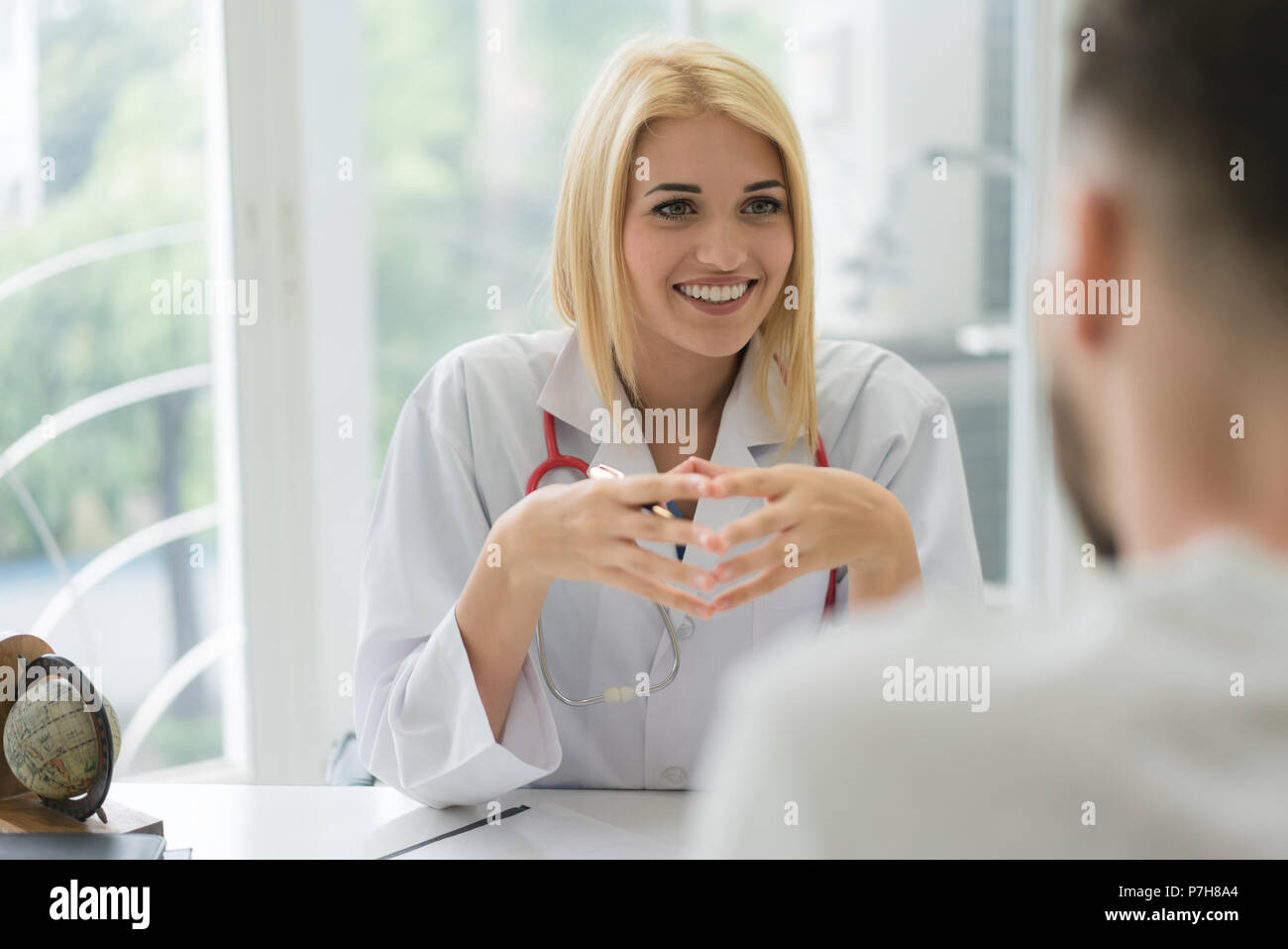 Doctor consulting male patient, working on diagnostic examination on