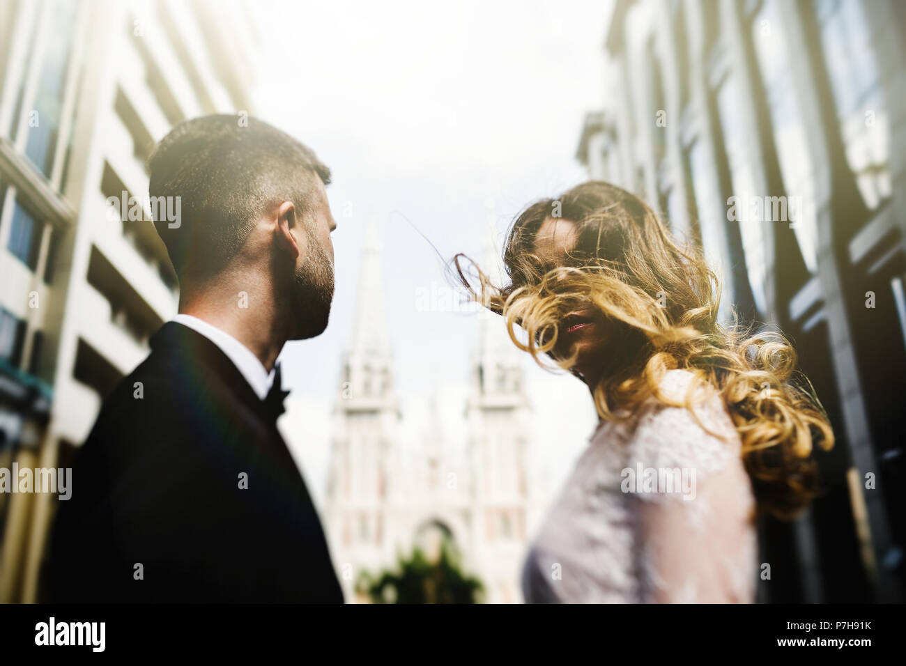 bride and groom posing on the streets of the old city Stock Photo - Alamy