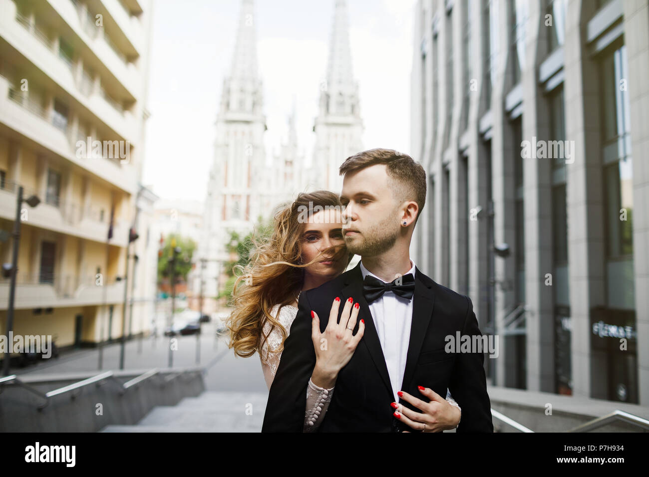 bride and groom posing on the streets of the old city Stock Photo - Alamy